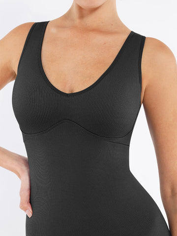 Black compression garment on a person against a white background